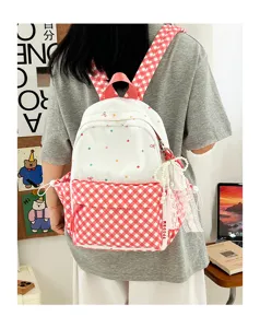 Süßer Rucksack mit Punkten und Karos für Mädchen, modernes Kontrastdesign mit Anhänger.
