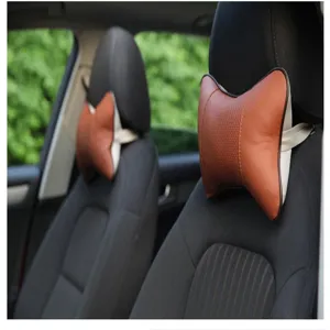 Detail shot of brown leather car neck pillow, breathable ergonomic headrest for auto seats.