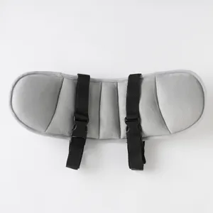 Close-up of grey kids car seat head support cushion with adjustable black straps and buckles.