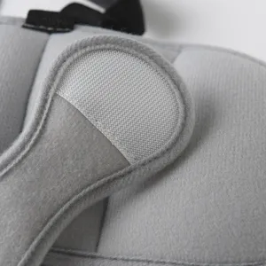 Detail shot of baby car seat head support strap, soft breathable fabric with secure velcro.