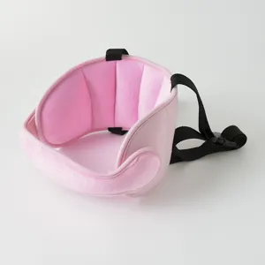 Closeup detail of baby car seat head support band, pink plush cushion with strap.