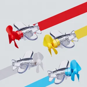 Close-up detail of transparent rotating light-up mini airplane toy with four colorful propeller options.