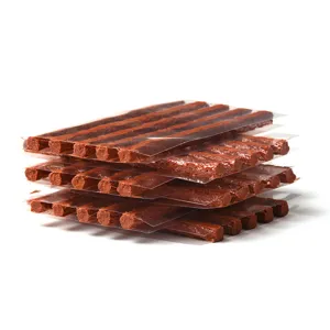 Detailed view of brown tire repair rubber strips stacked neatly on clean white background.
