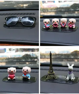 Car dashboard anti-slip sticky pad silicone phone mat with cute animal ornaments for auto interior use.