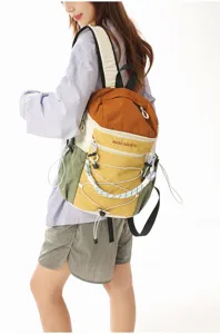 Stylish colorblocked outdoor backpack with bungee cord design for commuting and light hiking.