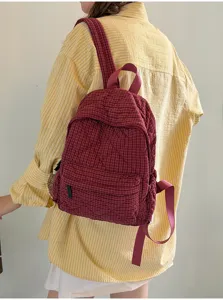 Red plaid quilted backpack for women, casual school bookbag with front pocket and top handle.
