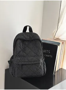 Black quilted grid backpack for women, casual school bookbag and lightweight daily commuting bag.