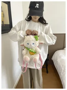 Cute cartoon plush sheep backpack with soft fluffy fleece material, pink straps and green decor.
