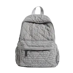 Grey quilted backpack detail view, checkered pattern fabric, casual student school bag close up