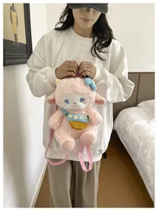 Cute pink sheep plush backpack detail view, soft fleece material with floral bag pendant.