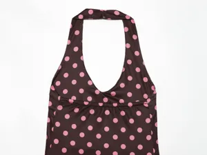 Close up view of brown polka dot halter top detail, stylish women summer clothing design.