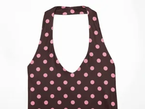 Close up detail of brown and pink polka dot halter neck top showcasing fabric and pattern.