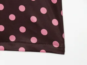 Polka dot print women clothing fabric and hem detail close up, premium material.