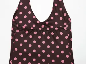 Close up of brown halter top with pink polka dots, featuring gathered detail under chest.