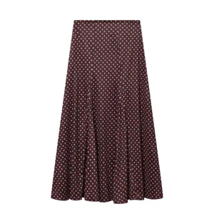 Detailed view of women's long A-line skirt featuring dark brown fabric and pink polka dots.