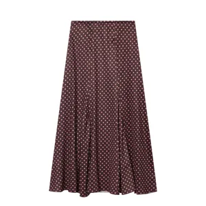 Brown pink polka dot skirt detail view, lightweight fabric with elegant drape and pleats.