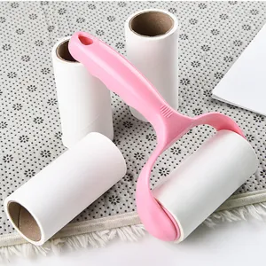 Lint roller with pink handle and tearable adhesive paper cores for easy clothing hair and dust removal.