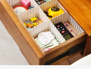 Close-up detail of plastic drawer dividers showing grid slot connection and neat organization.