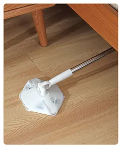 Detail view of the flat mop with telescopic handle cleaning under the bed, home use scene.