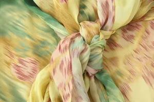 Close up detail view of stylish abstract printed fabric knot dress, elegant feminine fashion.