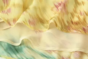Close-up detail shot of the layered floral chiffon fabric, showing exquisite stitching.