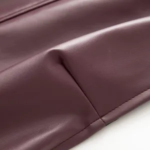 Burgundy faux leather fabric detail close-up showing fine stitching craftsmanship.