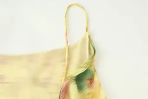 Detailed view of women floral print camisole thin strap and soft lightweight fabric.