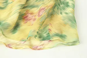 Close-up detail of the lightweight printed fabric dress hem, showing smooth flow and fine stitching.
