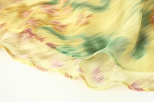 Fabric detail view of the floral printed dress, showing lightweight texture and fine stitching hem.