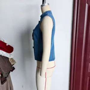 Side view of blue denim sleeveless vest showing tailored fit and detailed button front closure.