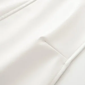 White faux leather fabric detail close-up showcasing fine stitching and smooth premium texture.