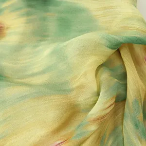 Green and yellow abstract print women dress fabric detail showcasing soft texture and drape.