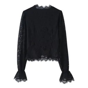 Detail view of a chic black lace long-sleeve top featuring delicate floral patterns and cuffs.