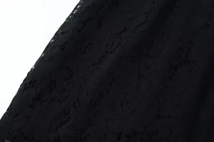 Detailed view of the elegant black lace fabric, showing delicate floral texture and fine craft.