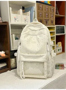 Detailansicht eines weissen Sternen-Schulrucksacks mit transparenter Tasche und Quasten.