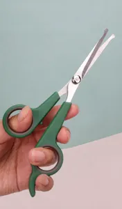Professional pet grooming scissors with ergonomic finger hook design for comfortable cutting.