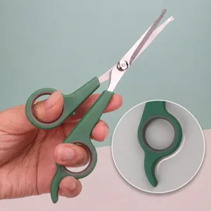 Pet grooming scissors with ergonomic green handle and special finger hook design for easy trimming.