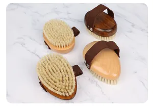 Wooden pet bath brush with natural bristles and elastic strap, closeup detail shot for grooming.