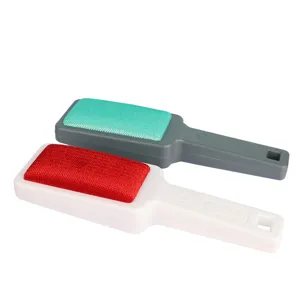 Double-sided lint remover brush for clothes, pet hair removal tool with ergonomic handle.