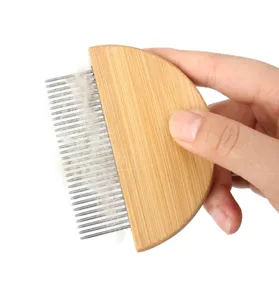 Wooden pet flea comb detail shot, metal teeth with pet hair, grooming tool close-up.