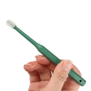 Green silicone pet toothbrush with 360 degree soft bristles for cat and dog oral care daily use.
