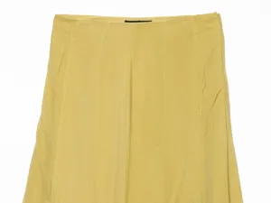 Detailed view of women's long skirt in yellow, featuring high waist and paneled seams.