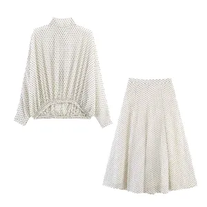 Chic polka dot long sleeve blouse and midi skirt set for women, elegant two-piece outfit.