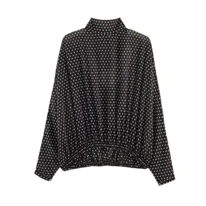 Elegant black and white polka dot long sleeve blouse featuring high neck and elastic hem.