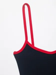Close-up detail of women's contrast trim ribbed tank top strap and neckline design.