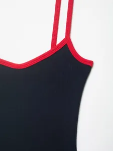Close-up of black ribbed bodysuit featuring striking red contrast trim straps and V-neckline.