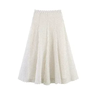 White midi skirt featuring classic black polka dots design, elegant flare silhouette, detail shot.