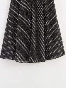 Black polka dot midi skirt detail, lightweight chiffon fabric texture, flared hemline view