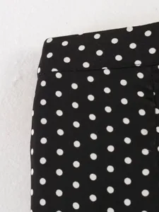Black and white polka dot fabric detail view, featuring clean waistband stitching for women.