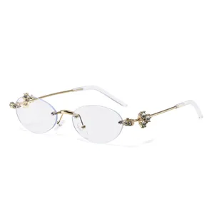 Gafas de sol ovaladas sin montura con diamantes de imitacion de lujo y montura dorada